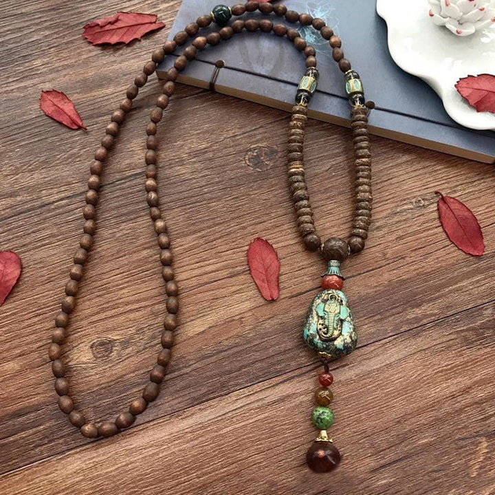 Collana con ciondolo a forma di testa di elefante, in legno wengé, fatto a mano in Tibet, con perline Dzi di protezione. - image 10