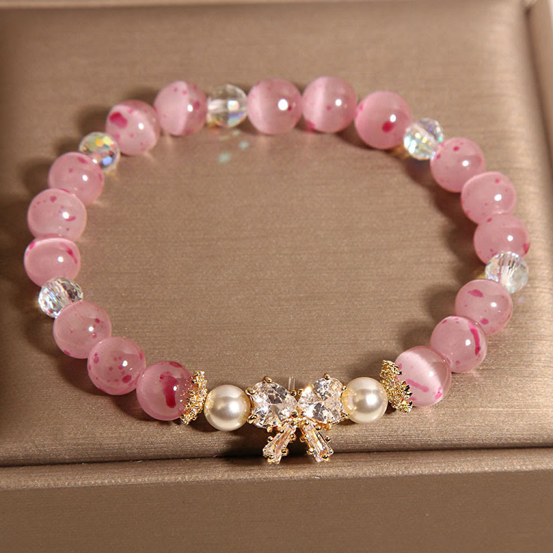Braccialetto di supporto con fiocco e rosetta, in perle occhio di gatto rosa e fiori di ciliegio Buddha Stones