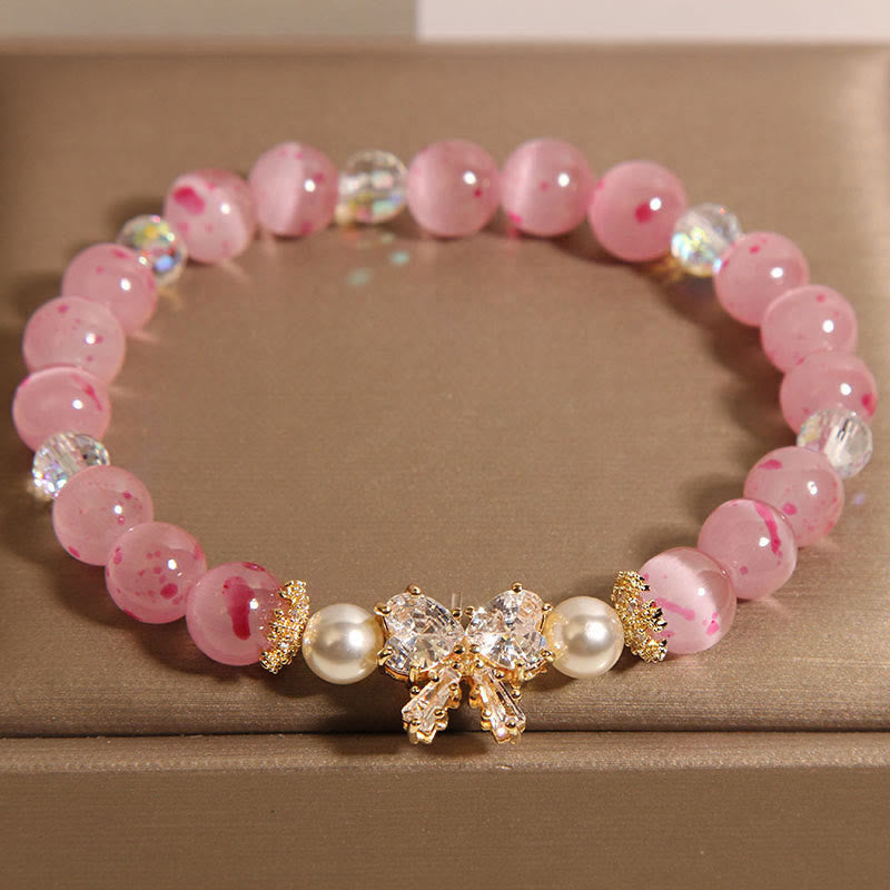 Braccialetto di supporto con fiocco e rosetta, in perle occhio di gatto rosa e fiori di ciliegio Buddha Stones
