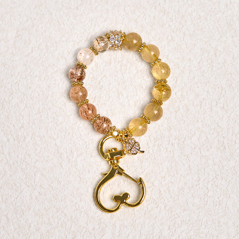 Portachiavi con ciondolo decorativo in quarzo rutilato dorato con Buddha Stones, simbolo di prosperità