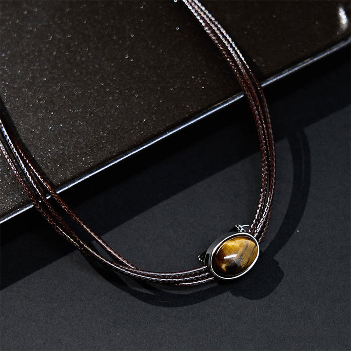 Collana con ciondolo in corda di cera con protezione ellittica in occhio di tigre naturale Buddha Stones