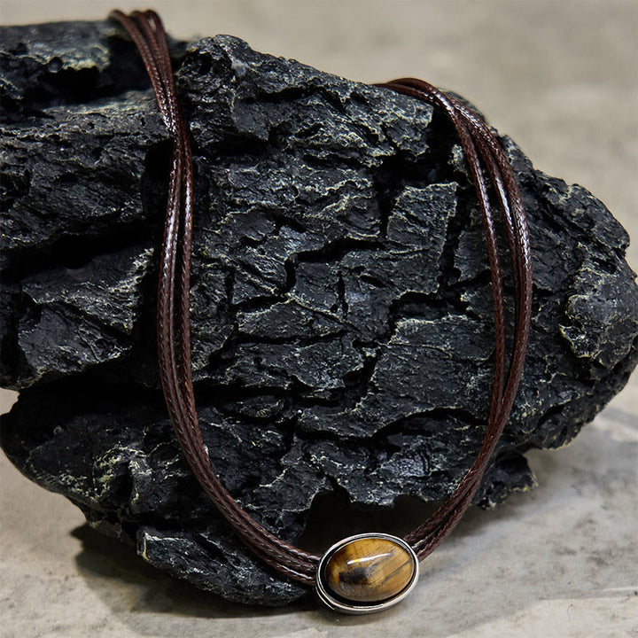 Collana con ciondolo in corda di cera con protezione ellittica in occhio di tigre naturale Buddha Stones