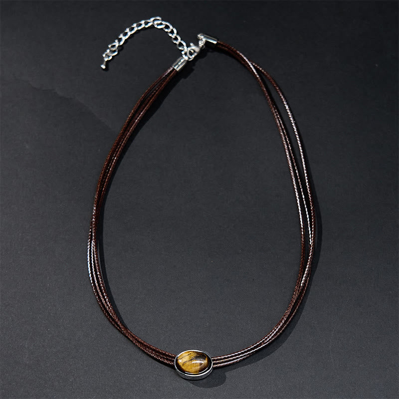 Collana con ciondolo in corda di cera con protezione ellittica in occhio di tigre naturale Buddha Stones