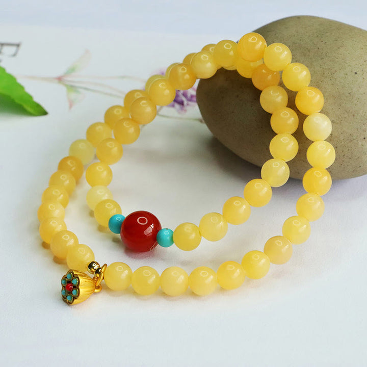 Bracciale della fortuna con perline di agata rossa e topazio Buddha Stones