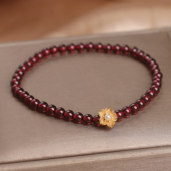 Bracciale Buddha Stones con perle di granato naturale da 4 mm e fiore della passione