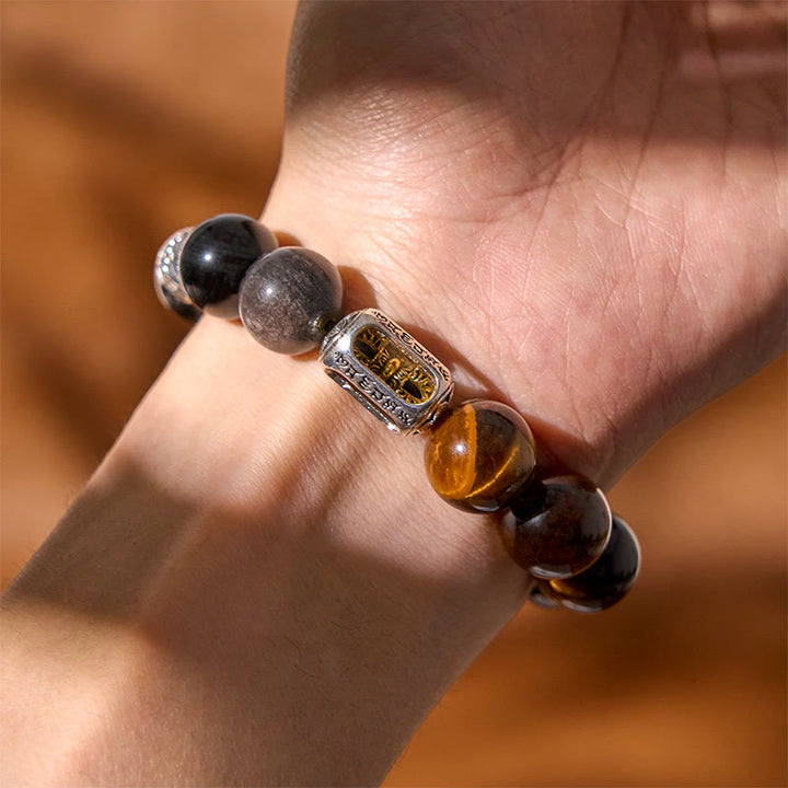 Bracciale di protezione Vajra in ossidiana naturale con occhio di tigre e argento lucido Buddha Stones