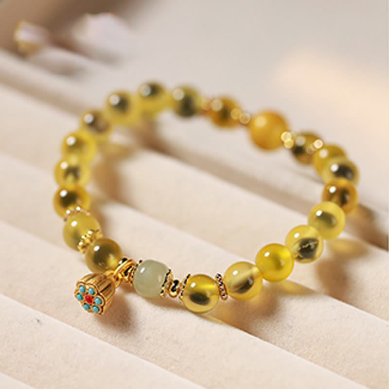 Braccialetto curativo con baccello di loto dorato in agata caramellata naturale colorata Buddha Stones - image 10