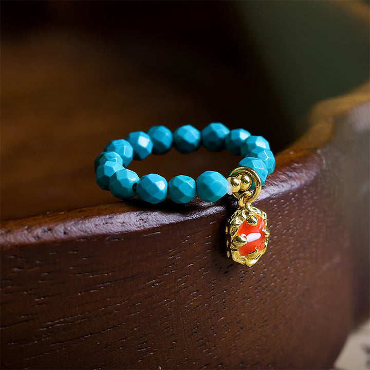Anello elastico con perline sfaccettate in turchese ultrafine da 4 mm, motivo Buddha Stones - Turchese (corda elastica) - image 0