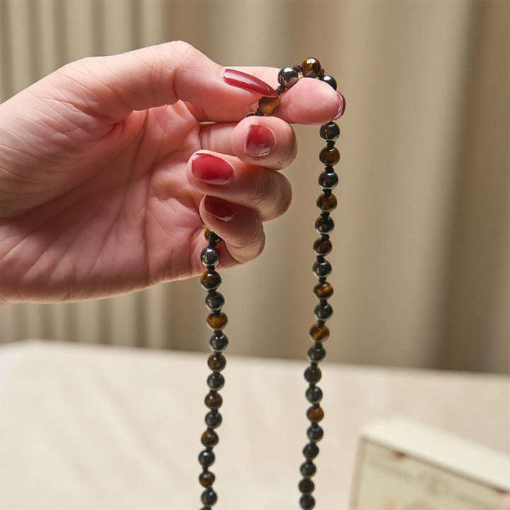 Mala con 108 Buddha Stones, occhio di tigre, ematite e nappa, coraggio e forza - image 4