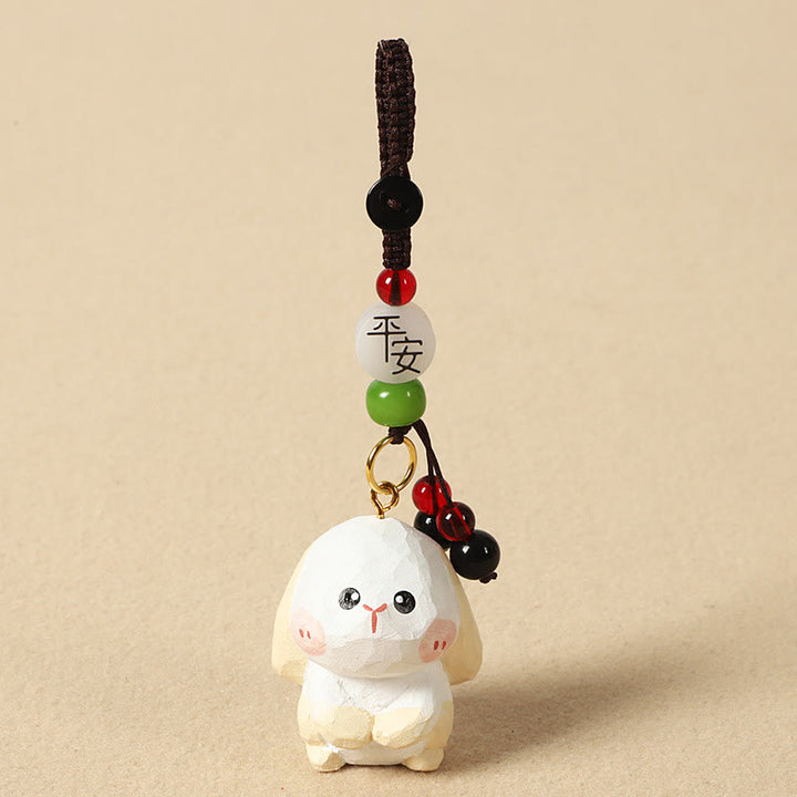 Buddha Stones Portachiavi in ​​legno di tiglio inciso con zodiaco cinese, fiore di pruno, pace e sicurezza, Om Mani Padme Hum, simbolo positivo. - Coniglio di 4 cm (colore, forma e dimensioni possono variare) - Pace e sicurezza - image 21