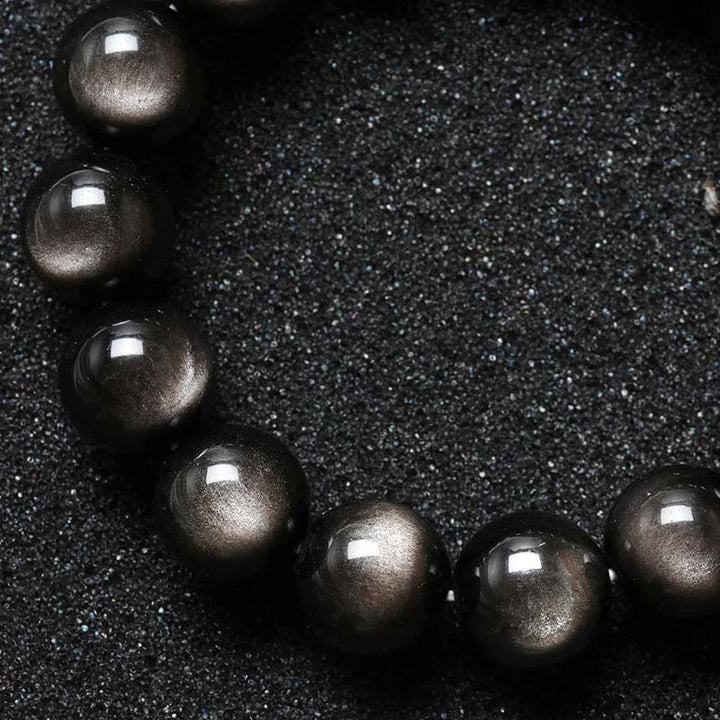 Braccialetto di protezione lenitiva in ossidiana lucida d'argento naturale Buddha Stones