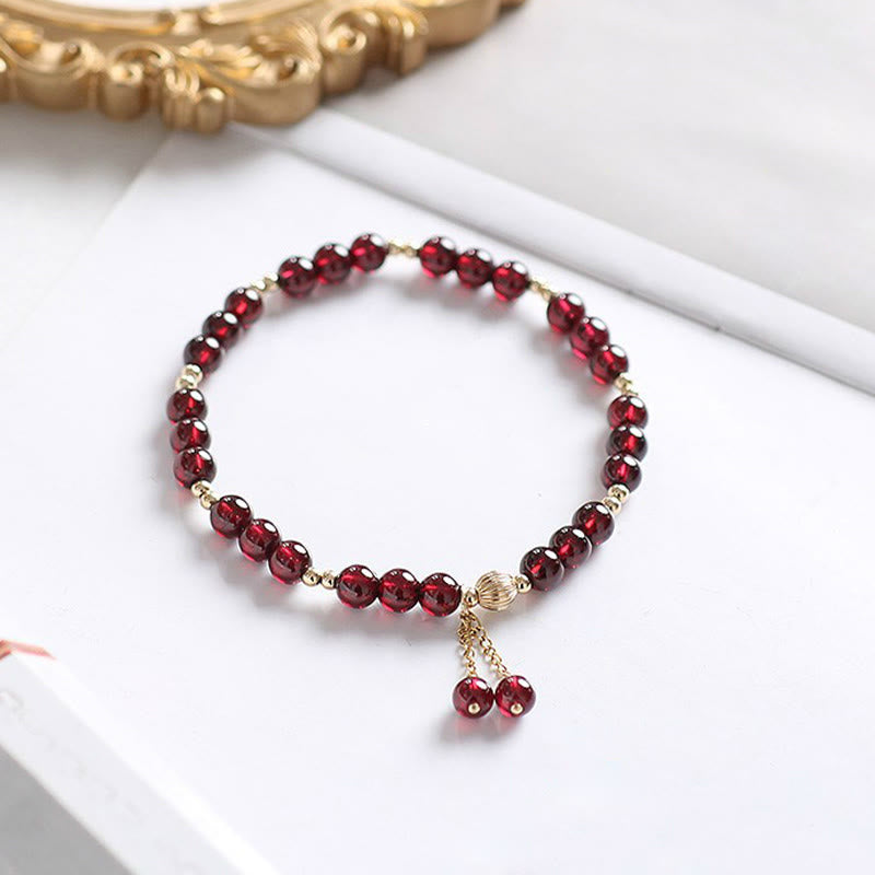 Bracciale Buddha Stones in lega placcata oro 14K con granato naturale e calma - image 1