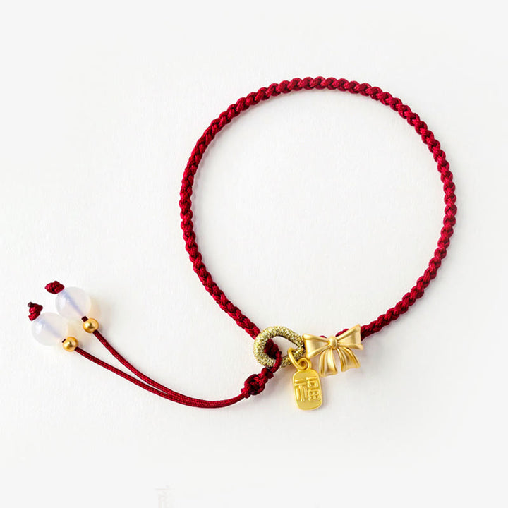 Braccialetto con corda rossa con ciondolo a forma di fiocco con rosetta in fiore di pesco fatto a mano con carattere Fu e nodo Buddha Stones