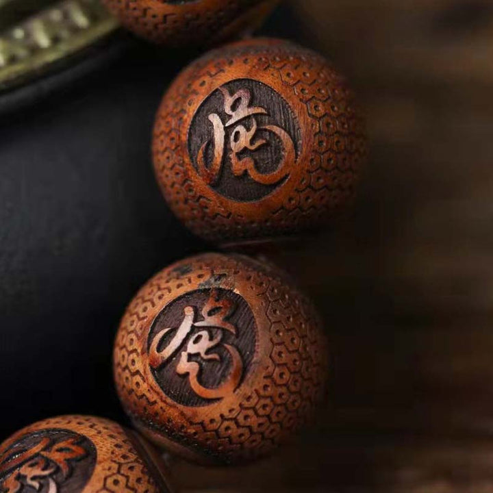 Braccialetto di protezione della tigre con incisione in palissandro tibetano e Buddha Stones