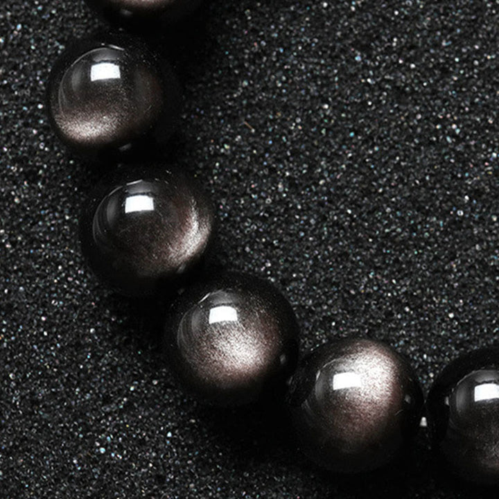 Braccialetto di protezione lenitiva in ossidiana lucida d'argento naturale Buddha Stones