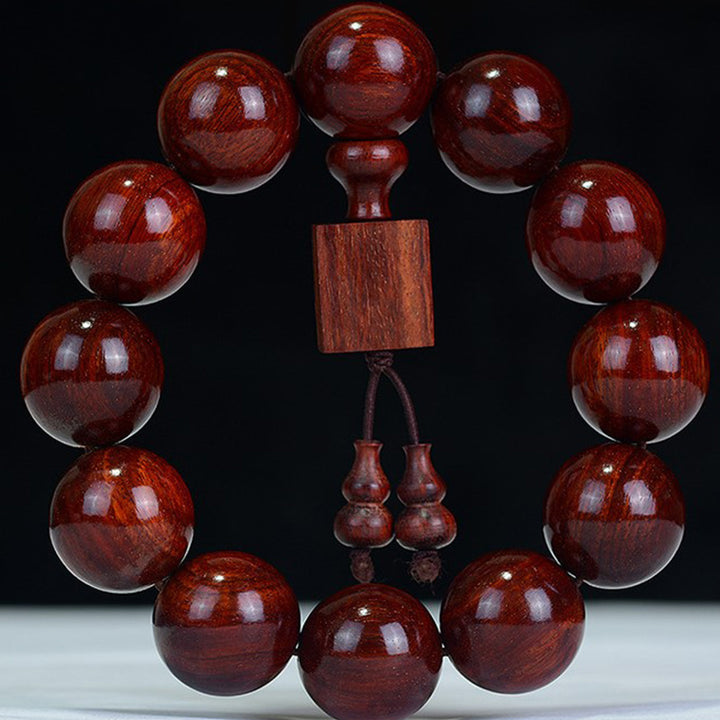 Braccialetto di rilassamento in legno di sandalo rosso con foglie piccole tibetane Buddha Stones