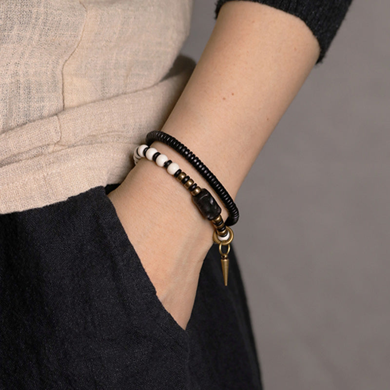 Braccialetto di coppia con perline di osso, ebano, Buddha Stones e rame