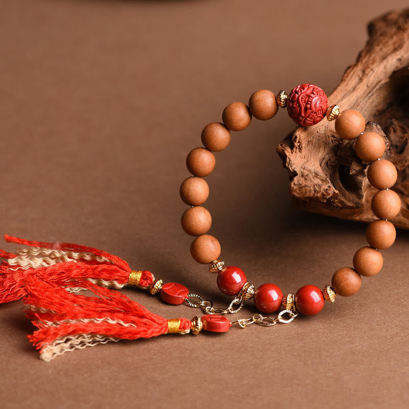 Braccialetto con nappe di ricchezza in legno di pesca naturale tibetano di cinabro PiXiu Buddha Stones
