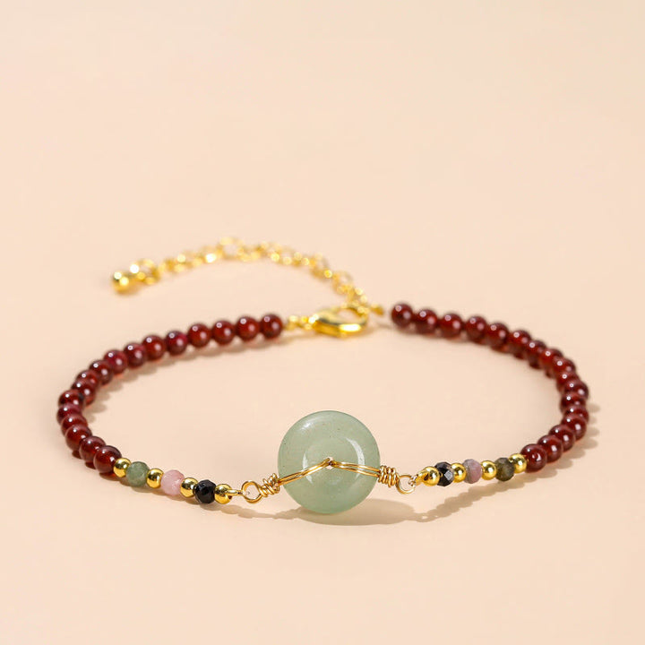 Braccialetto di perline con fibbia della pace in granato naturale Buddha Stones