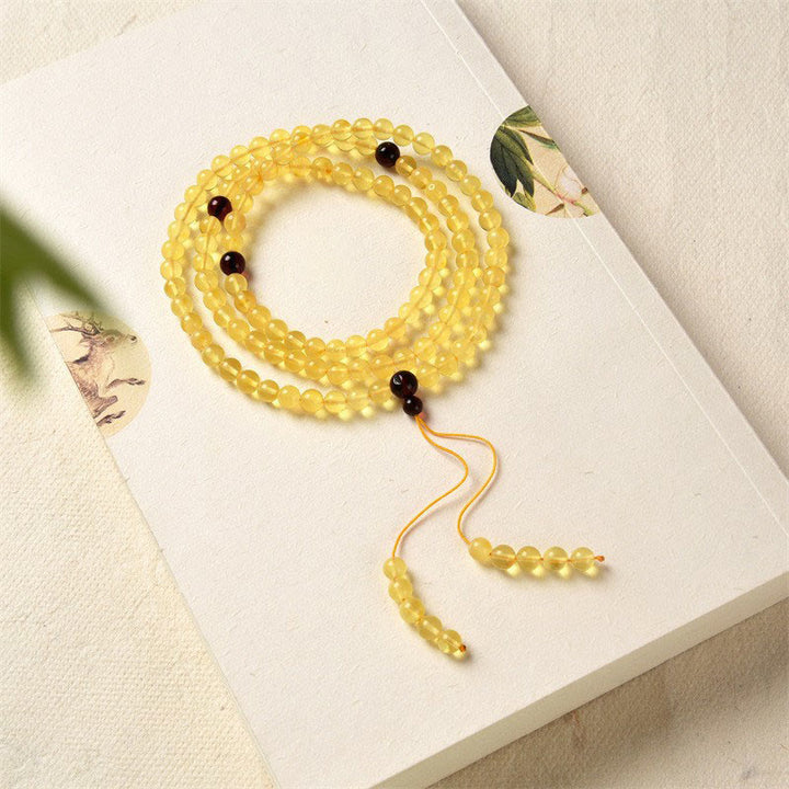 Braccialetto anti-ansia con 108 perline di mala in ambra naturale e trasparente Buddha Stones