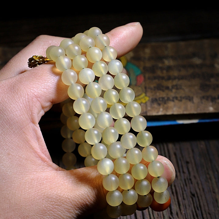 Braccialetto della fortuna in ambra e corno di pecora del Tibet con 108 perle di Mala Buddha Stones