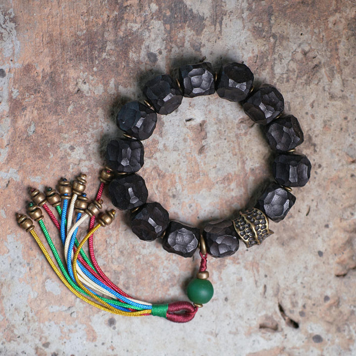 Bracciale Mala da polso con nappa in legno di Buddha Stones tibetano e rame della pace