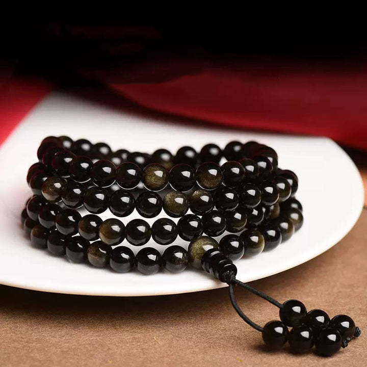 Braccialetto della ricchezza in ossidiana naturale con 108 perle di Mala Buddha Stones