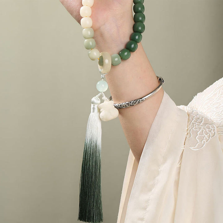 Buddha Stones Naturale Gradiente Bodhi Seed Fortuna Sacchetto di Denaro Loto Saggezza Nappa Polso Mala