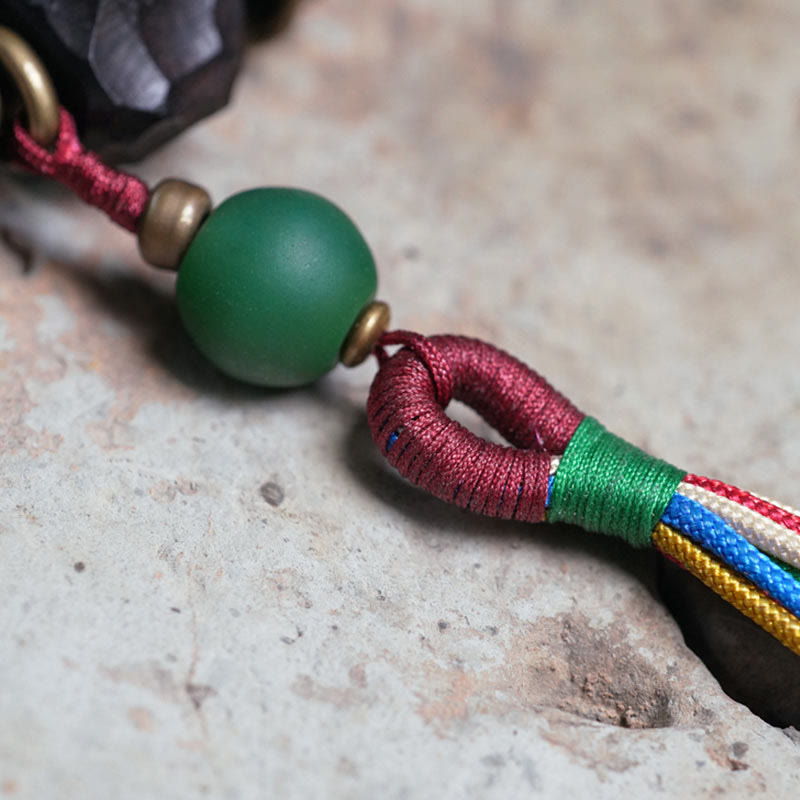 Bracciale Mala da polso con nappa in legno di Buddha Stones tibetano e rame della pace