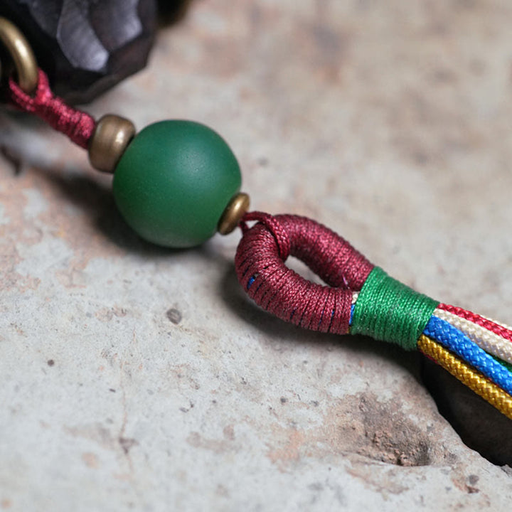 Bracciale Mala da polso con nappa in legno di Buddha Stones tibetano e rame della pace