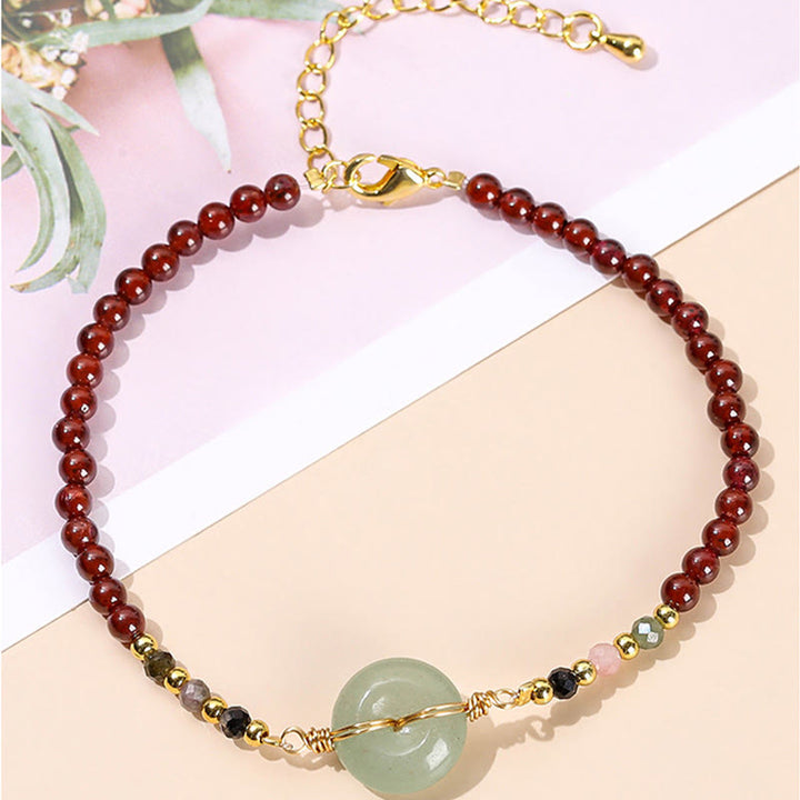 Braccialetto di perline con fibbia della pace in granato naturale Buddha Stones