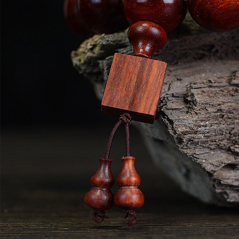 Braccialetto di rilassamento in legno di sandalo rosso con foglie piccole tibetane Buddha Stones
