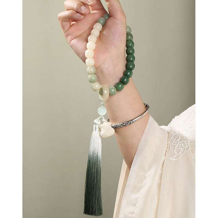 Buddha Stones Naturale Gradiente Bodhi Seed Fortuna Sacchetto di Denaro Loto Saggezza Nappa Polso Mala