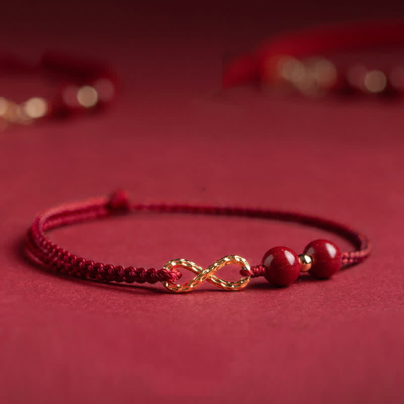 Braccialetto alla cavigliera con simbolo dell'infinito dorato e cordino rosso con Buddha Stones e cinabro. - Rosso scuro - Cavigliera (circonferenza della cavigliera 16-26 cm) - image 0