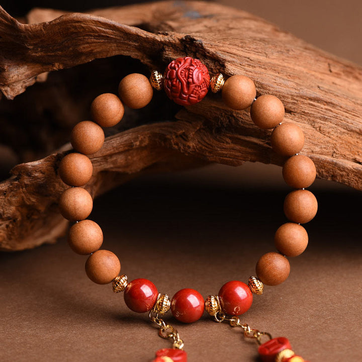 Braccialetto con nappe di ricchezza in legno di pesca naturale tibetano di cinabro PiXiu Buddha Stones