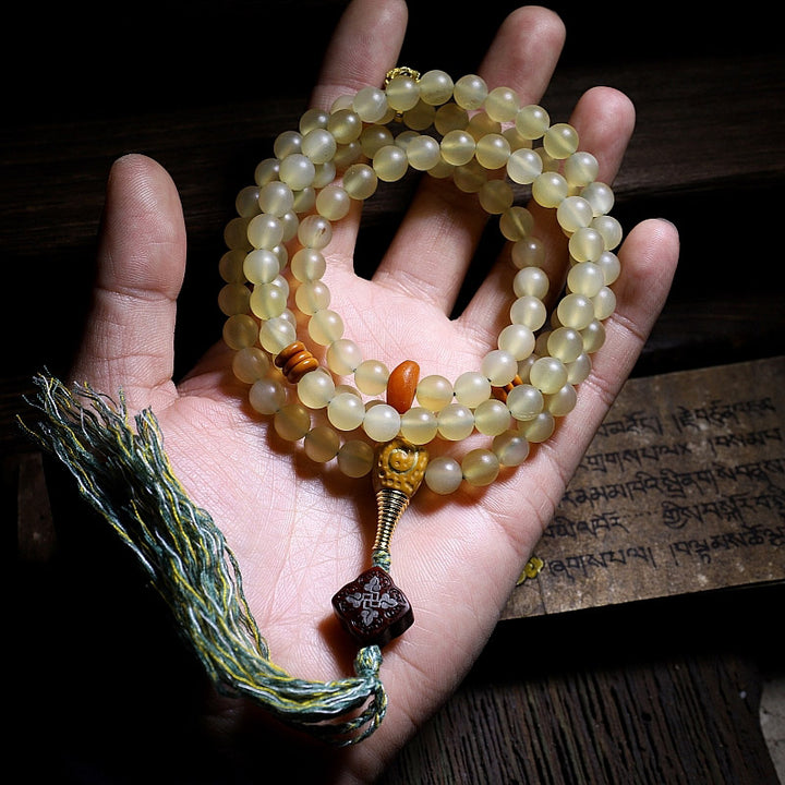 Braccialetto della fortuna in ambra e corno di pecora del Tibet con 108 perle di Mala Buddha Stones
