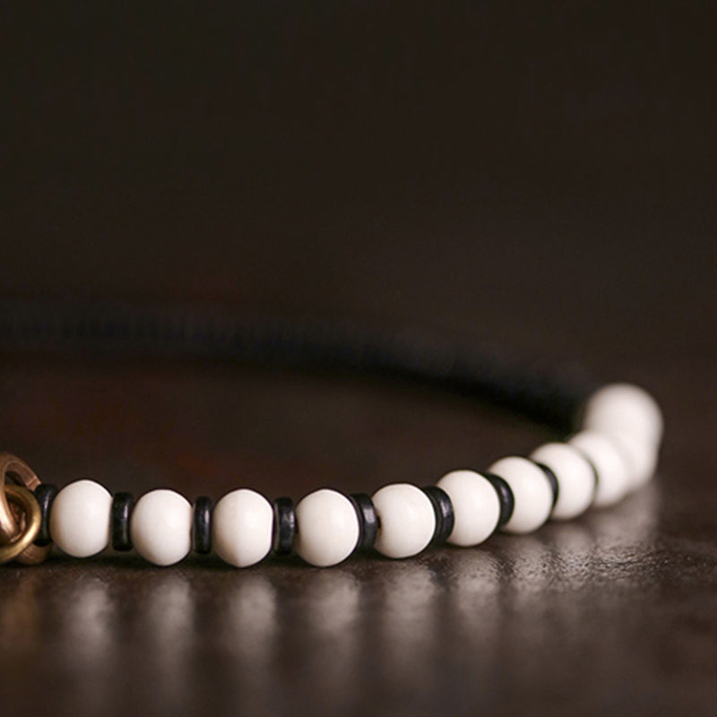 Braccialetto di coppia con perline di osso, ebano, Buddha Stones e rame