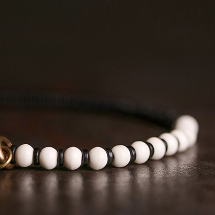 Braccialetto di coppia con perline di osso, ebano, Buddha Stones e rame
