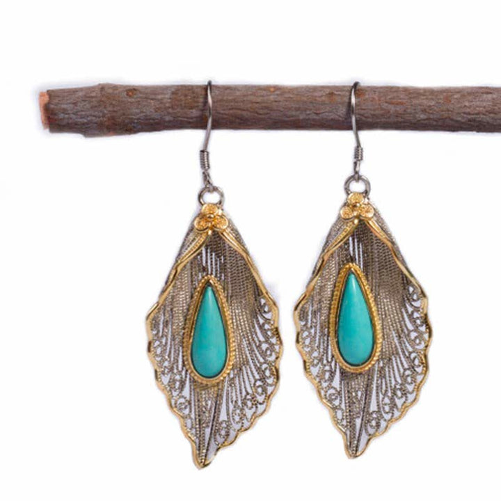 Orecchini pendenti con motivo a foglia di Bodhi in argento sterling 925 con Buddha Stones e turchese