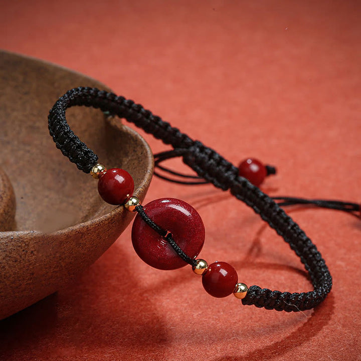 Braccialetto di corda di benedizione con fibbia della pace in cinabro naturale Buddha Stones