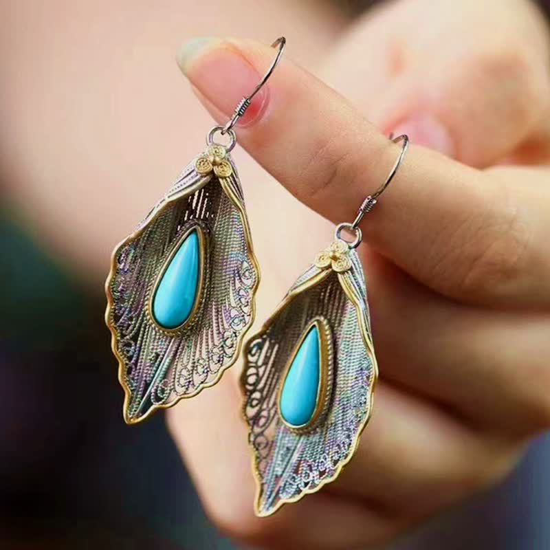 Orecchini pendenti con motivo a foglia di Bodhi in argento sterling 925 con Buddha Stones e turchese