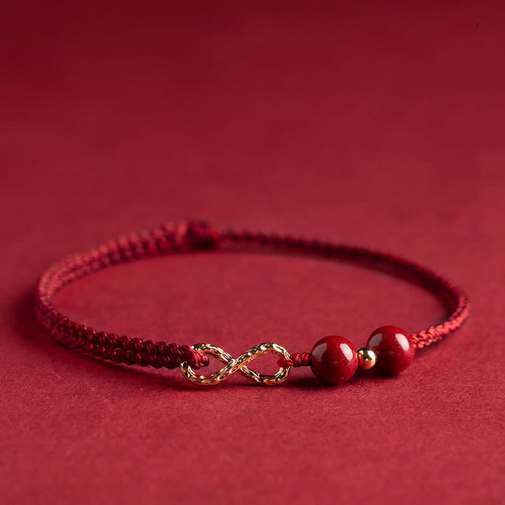 Braccialetto alla cavigliera con simbolo dell'infinito dorato e cordino rosso con Buddha Stones e cinabro. - image 2