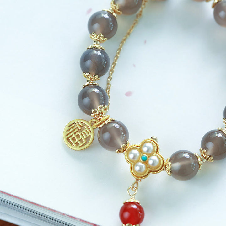 Braccialetto di equilibrio con nappa di perle di carattere Fu in agata grigia naturale Buddha Stones